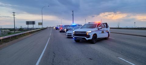 police cars lined up at an angle on a blocked road